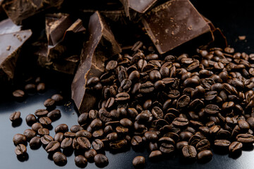 dark organic chocolate and coffee beans on concrete background