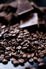 dark organic chocolate and coffee beans on concrete background