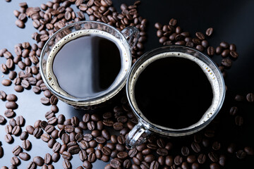 Horizontal shot of espresso and roasted coffee beans, close-up