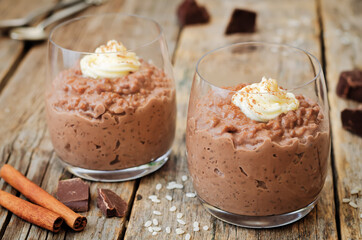 chocolate rice pudding decorated with whipped cream with cinnamon