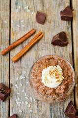chocolate rice pudding decorated with whipped cream with cinnamon