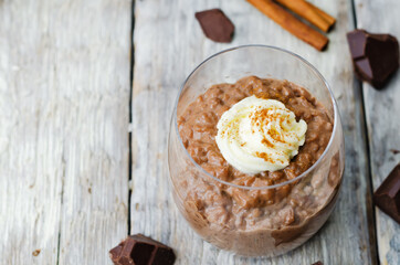 chocolate rice pudding decorated with whipped cream with cinnamon