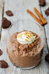chocolate rice pudding decorated with whipped cream with cinnamon