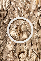 Fall composition with frame made of autumn golden leaves. Trendy luxury fashion design. Natural botany floral composition. Flat lay, top view, copy space.