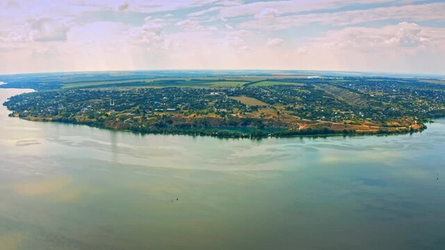 Aerial view over beautiful suburb with a wide river with  privat houses.  Top view over  a  people settlement near water.