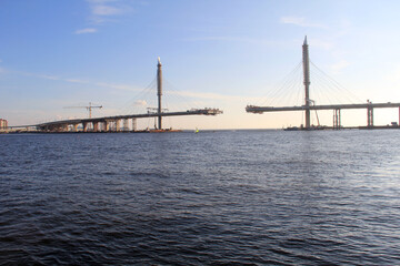 Fototapeta na wymiar Construction of a large bridge across a wide river