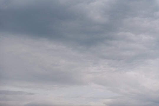 Grey sky. The sky is overhead. Clouds at sunset. The sky before the storm. Cumulus clouds. Gloomy sky