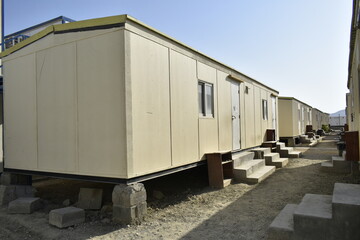Obraz na płótnie Canvas Portacabin, porta cabin, temporary labors camp , Mobile building in industrial site or office container Portable house and office cabins. Labor Camp. Porta cabin. small temporary houses