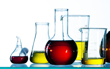 Different laboratory glassware with color liquid and with reflection