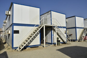 Naklejka premium Portacabin, porta cabin, temporary labors camp , Mobile building in industrial site or office container Portable house and office cabins. Labor Camp. Porta cabin. small temporary houses