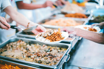 The concept of begging food : Hands of the poor are waiting for food donations to alleviate hunger