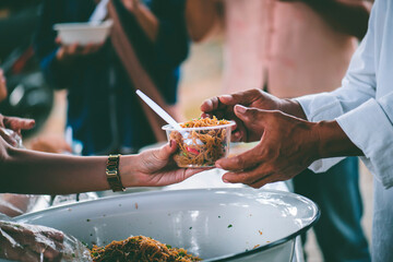 The concept of begging food : Hands of the poor are waiting for food donations to alleviate hunger