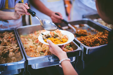 Donate food to people in society : The hands of the poor receive food from the hands of the philanthropist