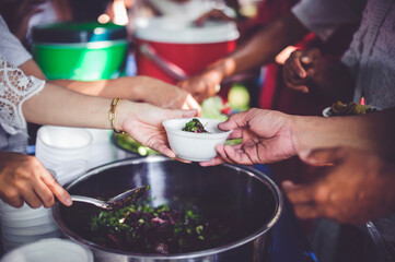 Donate food to people in society : The hands of the poor receive food from the hands of the philanthropist