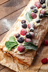 Closeup on meringue roll with berries 