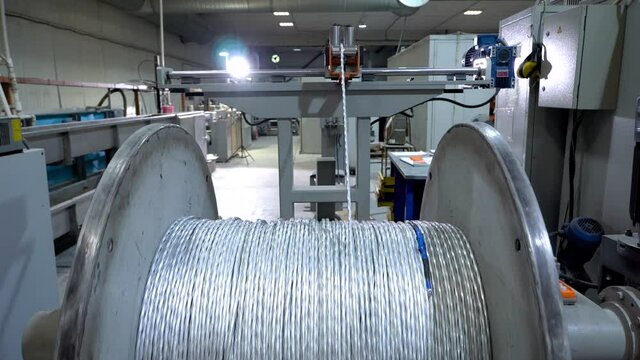 an electrical cable in isolation is wound on a metal coil