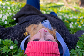 The girl lies on the ground.