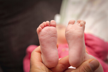 baby feet in father's hand