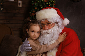 Santa Claus and child at home. Christmas gift. Family holiday concept.
