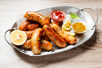 Homemade chicken  sausages fried and stewed in garlic butter sauce.