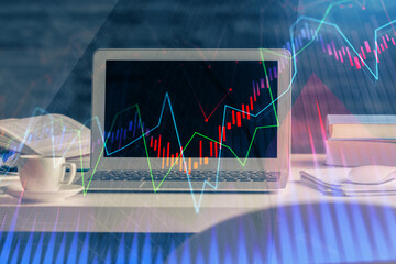 Forex market graph hologram and personal computer on background. Multi exposure. Concept of investment.