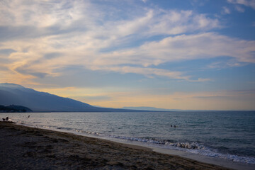 Fototapeta na wymiar cold sunny cloudy sunset on the beach