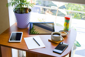 Working from home, workspace with digital tablet and mobile phone, coffee and work