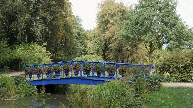 Blue bridge in Furst Puckler Park in Bad Muskau town, Germany.