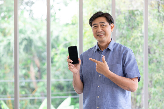 senior asian man showing smartphone at home