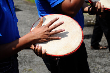 KUALA LUMPUR, MALAYSIA -MARCH 2, 2019: Boy plays kompang during Malay traditional wedding ceremony....