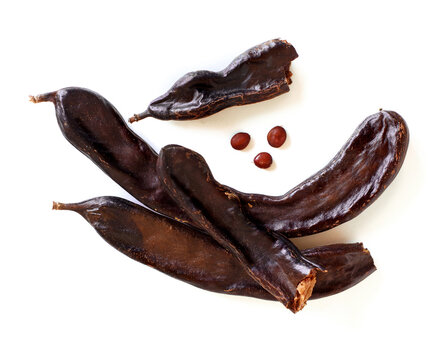 Dry carob pods and seeds close up