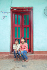 Rural Indian village girls in their village seating at home corridor