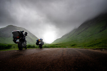 two motor bikes on road trip on small scottish road on foggy and misty day