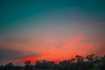 Obraz premium beautiful pink cloudy sunset at the fields 