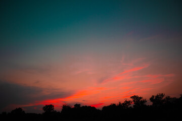 Fototapeta na wymiar beautiful pink cloudy sunset at the fields 