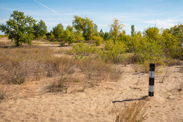 Border pillars in a desert sandy area - landscape