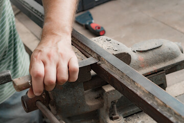 Male carpenter working on old wood in a retro vintage style.