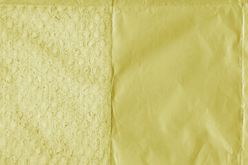 Yellow vintage and old looking crumpled paper background. Retro cardboard texture. Grunge paper for drawing. Ancient book page. Present wrapping.