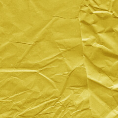 Yellow vintage and old looking crumpled paper background. Retro cardboard texture. Grunge paper for drawing. Ancient book page. Present wrapping.