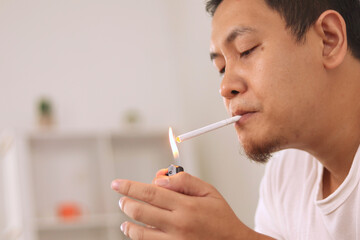 Asian man lights a cigarette and smoking