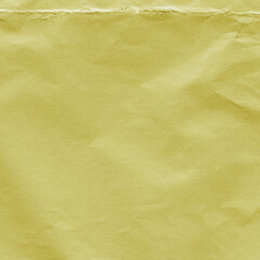 Yellow vintage and old looking crumpled paper background. Retro cardboard texture. Grunge paper for drawing. Ancient book page. Present wrapping.
