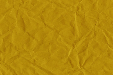 Yellow vintage and old looking crumpled paper background. Retro cardboard texture. Grunge paper for drawing. Ancient book page. Present wrapping.