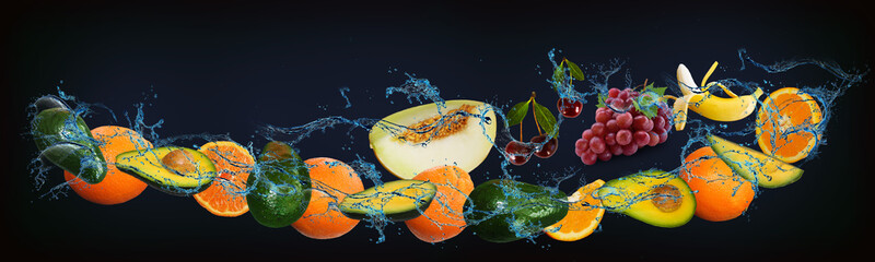 Panorama with fresh fruits in the water - pineapple, orange, avocado, melon, grapes, banana, a very...