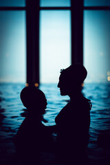 silhouette of a person in the pool