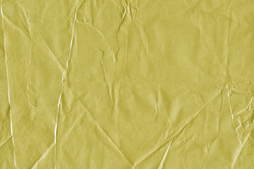 Yellow vintage and old looking crumpled paper background. Retro cardboard texture. Grunge paper for drawing. Ancient book page. Present wrapping.