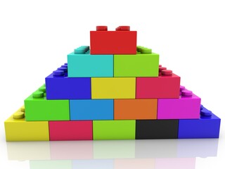 Colored toy bricks stacked in the form of a pyramid on white