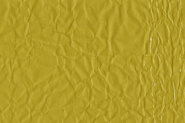 Yellow vintage and old looking crumpled paper background. Retro cardboard texture. Grunge paper for drawing. Ancient book page. Present wrapping.