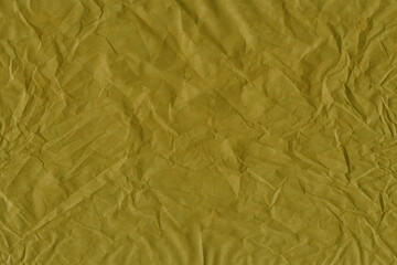 Yellow vintage and old looking crumpled paper background. Retro cardboard texture. Grunge paper for drawing. Ancient book page. Present wrapping.