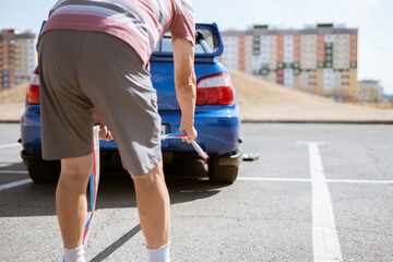 man holding a towing rope and install it on the car hook, the auto accident and problem with engine