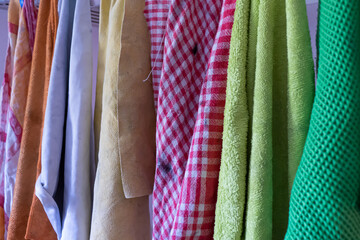 Cleaning cloths hang next to each other to dry on a line, concept of cleanliness, purity and house cleaning